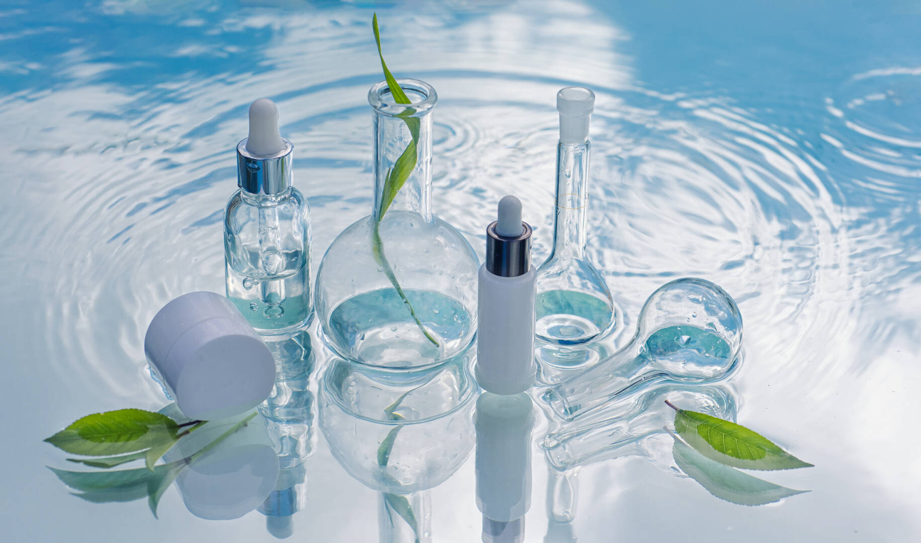 Natural organic cosmetics in white packages and laboratory glassware Banner